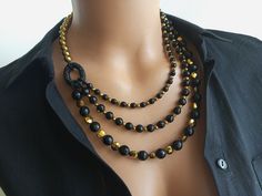 Meet our elegant Onyx and Hematite Multi-Strand Beaded Necklace, a modern and versatile accessory that is sure to attract attention. Handmade with love and attention to detail, this necklace displays a stunning combination of onyx and hematite natural stone beads, effortlessly blending elegance with a subtle touch. This statement piece is not just a necklace; It is a work of art for women that reflects your unique sense of style and elegance. MATERIALS: Each bead in this necklace has been carefu Necklace Displays, Black Beaded Necklace, Multi Strand Beaded Necklace, Hematite Necklace, Natural Stone Jewelry, Onyx Bead, Necklace Statement, Necklace Sizes, Necklace Handmade