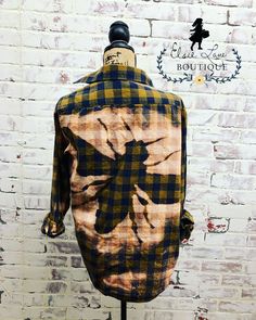 a mannequin wearing a plaid shirt with an image of a flower on it