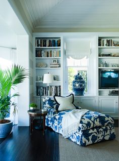 a living room filled with furniture and bookshelves