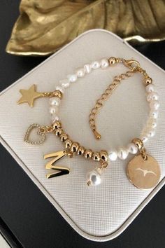 "Stylish an beautiful freshwater pearl personalized handmade bracelet  is handcrafted with beautiful high quality 5-6 mm freshwater pearl, golden plated 5 mm beads,  with hanged Baroque Round 8mm White pearl, star pendant, heart pendant with crystals, personal name letter and Gold-Tone disc, which can be engraved with personal words (up to 10 letters).  Finished with golden plated lobster clasp and extender to fit wrist comfortabily. Bracelet length - 16 cm (6 inch). You can order Your own size Gift Pearl Bracelet With Baroque Pearl Charm, Baroque Pearl Bracelet With Pearl Charm As Gift, Gold Pearl Beaded Bracelets With Letter Beads, Gift Baroque Pearl Bracelet With Pearl Charm, Personalized Gold Pearl Beaded Bracelets, Personalized Round Bead Pearl Bracelet In Elegant Style, Elegant Pearl Beaded Bracelets With Letter Beads, Elegant Pearl Bracelet With Letter Beads, Personalized Round Bead Pearl Bracelet