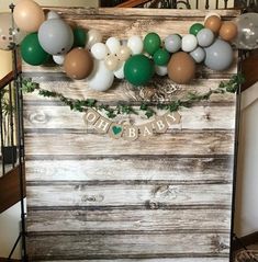 a wooden box with balloons and garland on it