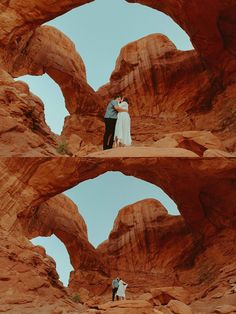 a man and woman standing in the middle of some rocks with their arms around each other