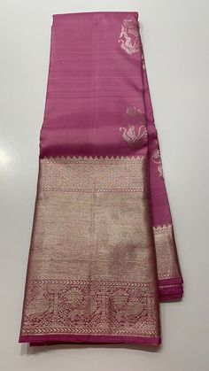 Experience elegance and ease with our Carnation Pink Kanjivaram Saree. Handwoven with pure silver zari, this saree comes with a stitched blouse and easy-to-drape design. The hand embroidered details add a touch of uniqueness to this one-of-a-kind saree. Available in sizes 36 to 42/43, it's a perfect addition to your wardrobe. Pure kanjivaram carnation pink silver  zari . This Carnation Pink kanjivaram saree features a delicate silver zari design with an elegant embroidered stitched blouse. Made with high-quality fabric, this saree is perfect for special occasions, adding a touch of sophistication to your wardrobe. Enhance your style and make a statement with this stunning piece. Unique one of a kind Kanjivaram with hand woven design , comes with prestitched blouse with hand embroidered des Traditional Silver Tissue Silk Pre-draped Saree, Traditional Silver Pre-draped Saree With Pallu, Designer Silver Blouse Piece With Traditional Drape, Silver Blouse Piece With Traditional Drape For Designer Wear, Designer Silver Saree, Designer Festive Silver Saree, Silver Silk Traditional Wear For Wedding, Designer Silver Saree With Zari Work, Silver Anarkali Saree In Traditional Drape