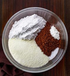 three different types of flour in a bowl on a table top next to a napkin