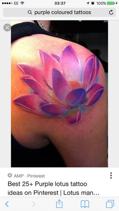 a woman's back shoulder with a pink flower painted on it