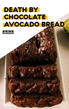 two slices of chocolate avocado bread on a white plate next to an avocado