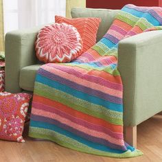 a couch with colorful blankets and pillows on it