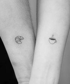 two people with matching tattoos on their wrists holding coffee mugs and cinnamons