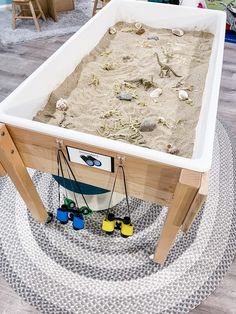 a sandbox is set up on top of a rug