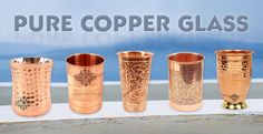 a group of copper colored cups sitting on top of a table