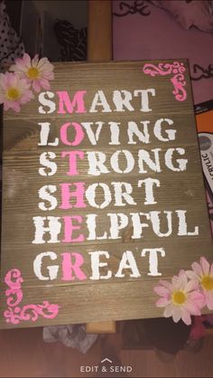 a wooden sign that says smart loving strong short helpful great with daisies on it