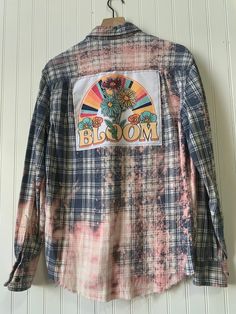 Bloom bleached & distressed flannel shirt  * This vintage blue and pink flannel was hand  bleached & distressed, with a multi step process creating a pink hued ombré effect,  and  a sublimated art panel sewn on to the back.  SIZING -  Small - message me for custom sizes. This flannel would be perfect for every day wear - or would be a great gift for the sunshiny person in your life. Great for on the boat,  or around the campfire!  * No one flannel will be the same *  Please keep in mind each flannel is uniquely handmade - bleaching and distressing will vary, all flannels are pre-washed, and ready to wear! Vintage Bleached Tops For Spring, Relaxed Fit Tie Dye Shirt For Spring, Trendy Flannel Shirt For Spring, Trendy Cotton Flannel Shirt For Spring, Spring Grunge Shirt With Relaxed Fit, Faded Bleached Top For Spring, Vintage Plaid Flannel Shirt For Spring, Grunge Bleached Tops For Spring, Bleached Grunge Tops For Spring