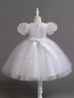 A touch of sweetness and a whole lot of elegance are in this beaded puff sleeve Communion dress. Designed to make special occasions even more magical with its glittering details and gorgeous beadwork, it's the ultimate twirl-worthy delight for your angel. Fluffy layers of lightweight fabric add a playful bounce to her moves, making each step extra charming. Sophisticated details elevate her look, ensuring a magical memory in the making. Perfect for Communion Day, weddings, pageants, birthday parties, dances, and other celebrations Puff sleeve tulle Communion dress with sequin details and beadwork waist accent Available in sizes 4T-12Y for toddlers and little girls Elegant Christmas Princess Dress In Tulle, Elegant Christmas Tulle Princess Dress, Elegant Festive Tulle Princess Dress, White Tulle Christmas Dress, Elegant Festive Tulle Dress, Elegant Puff Sleeve Princess Dress For Wedding, White Puff Sleeve Organza Dress, White Organza Dress With Puff Sleeves, Princess Style Puff Sleeve Dress For Party