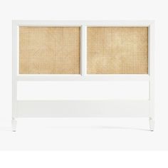 a white headboard with rattan panels on it