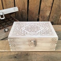 a wooden box sitting on top of a table next to an open case filled with jewelry