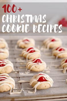 cookies with white frosting and red icing are on a cooling rack in front of the words, 100 + christmas cookie recipes