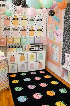 a room decorated with lots of different colored paper lanterns and other decorations on the wall