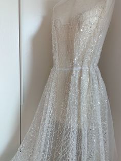 White Sequin Gown For Debutante Ball, Embellished Sequin Tulle Dress For Wedding, Elegant White Glitter Dress, Embellished Glitter Tulle Gown For Wedding, Elegant Lace Sequin Wedding Dress, Glamorous White Sequin Wedding Dress, White Sheer Gown For Party, Glamorous Tulle Fabric For Wedding, Glamorous White Sequin Dress For Wedding