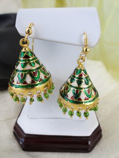 Indian minakari dangling "jhumki" earrings. Meenakari, also called enamelling, is the art of decorating a metal surface by fusing mineral substances to it. Meenakari was introduced to India by the Mughal kings in the early 16th century. So, this delicately designed ear ring comes from workmanship which dates back to some 400 hundred years.The meenakari work is very similar in craftsmanship to the miniature design and coloring on the famous Faberge eggs. The design is etched into the metal and th Jhumki Earrings, Faberge Eggs, Indian Earrings, Indian Jewellery, Indian Jewelry, Handmade Jewelry, Miniatures, Drop Earrings, Color