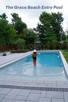 a woman in a black bathing suit jumping into a swimming pool with the caption, the grace beach entry pool