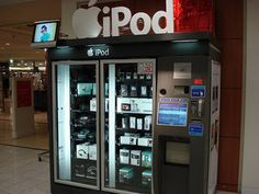 an apple ipod vending machine in the middle of a shopping mall with it's doors open