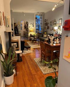 a living room filled with furniture and a cat sitting on top of a wooden table