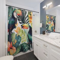 a bathroom with a shower curtain decorated with tropical flowers and toucan birds on it