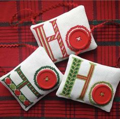 two red and green christmas pillows with buttons on each one that says hope, hope