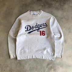 DODGERS Mlb Team Nomo 16 Crewneck Sweatshirt TAG : Salem Sportswear SIZE : Large MEASUREMENT , - Width (Armpit to armpit) : 22.5" - Length (Shoulder the end of garment) : 27.5" - Shoulder : 22" - Sleeve Length : 23.5" CONDITION : Distressed on collar and ring sleeves. Got pinhole on back sleeve. But still in great vintage used. No problem on print ** PLEASE LEAVE ME YOUR PHONE NUMBER ON THE NOTE AFTER MADE A PURCHASE, ITS FOR COURIER NEEDED ** SHIPPING, all item will be shipped with tracking num Throwback Crew Top For Sports, Throwback Crew Neck Top For Sports Events, Throwback Crew Sports Top, Throwback Crew Neck Sweatshirt With Team Logo, Crew Neck Sweatshirt For Streetwear And Baseball Season, Throwback Long Sleeve T-shirt For Sports Events, 80s Neon Outfit, Dodger Shirt, Dodger Crewneck