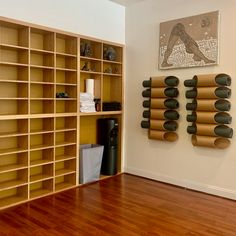 a room with wooden floors and shelving units