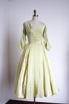 "Incredibly unique and gorgeous green party dress from the 1950s. This dress features the coolest asymmetrical bust details I've seen on a 50s dress! Then it also has these cool ruched dolman sleeves, a fitted waistline, a full skirt with striped green panels over the sides! It's just so special . Label: by Marigold No Houser . Measurements: { xsmall } Bust: 34\" Waist: 24\" Hips: open Length: 48\" Sleeve Length: 18\" . Condition: nearly excellent vintage condition with minor signs of wear - fai 1930s Green Dress, 1950's Dresses, Houndstooth Dress, Rayon Dress, 50s Dresses, 1950s Dress, Historical Dresses, Star Dress, Dress Purchase