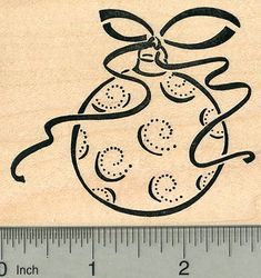 a wooden rubber stamp with an image of a christmas ornament on it's side