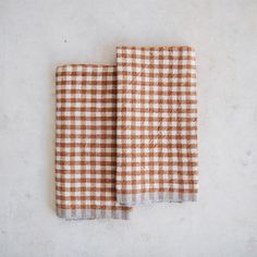 two brown and white checkered cloths sitting on top of each other