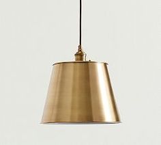 a gold pendant light hanging from a ceiling