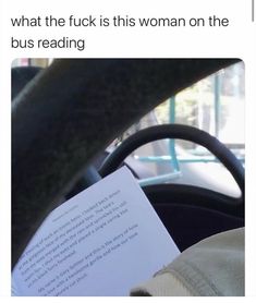 someone is reading a book in the car