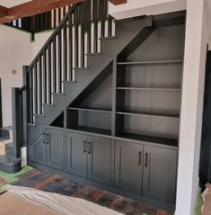 an empty room with cabinets and stairs in it