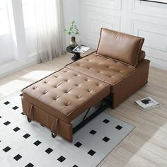 a brown leather couch sitting on top of a white rug