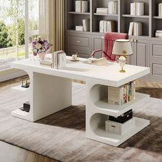 a white desk with bookshelves in front of it and a lamp next to it