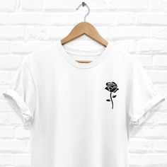 Rose T-Shirt / Long Sleeve T-Shirt  by MugsByThugs [Black Rose Shirt, Rose Tshirt, Pocket Rose T Shirt, Roses White Tee, Hypebeast Clothing, Trendy T-Shirt, Streetwear Shirts for Men and Women]  Design is printed on the front side of a high quality, soft and comfortable tee shirt. Printed using digital DTG (direct to garment) printing technique, to ensure a long lasting, high quality print and vibrant colors. All garments are printed and shipped from USA. Adult Unisex T-Shirt Short sleeves (sleeves in photos are rolled up manually, shirt will arrive with unrolled sleeves). Classic fit; Men-Unisex sizing >> Please refer to the SIZE CHART in photos, to make sure you order the best size for you.  100% Cotton Preshrunk jersey knit Double-needle collar, sleeves and bottom hems Taped neck and sh Rose Tshirt, Hypebeast Clothing, Pop Pop Shirts, Streetwear Shirts, Rose Shirts, Roses White, Rose T Shirt, Shirt Streetwear, Trendy Tshirts