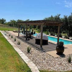 an outdoor patio area next to a swimming pool