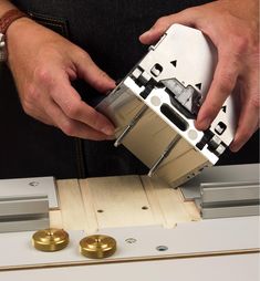 a man is working on some type of device with metal parts attached to the machine