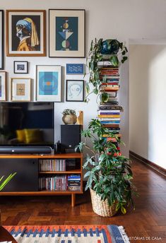 a living room filled with furniture and pictures on the wall