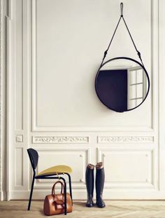 a room with a chair and mirror on the wall