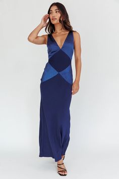 a woman is wearing a blue dress with an open back and side cutouts on it