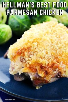 a piece of chicken parmesan casserole on a blue plate with brussel sprouts in the background