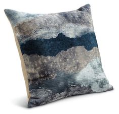 a blue and gray pillow on a white background