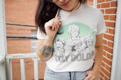 a woman wearing glasses and a t - shirt with the words stay gold on it