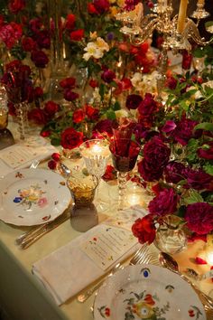 the table is set with flowers and candles