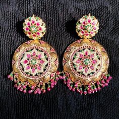 Gold plated chandbali earrings in 92.5 silver. The setting stones are synthetic rubies and emeralds. All pearls used are real freshwater pearls. The hanging beads are real rubies and emeralds. Weight - 65 GMs Height - 9.25 cms Width - 5.25 cms Fusion Style Jeweled Jhumkas For Festivals, Festive Jeweled Fusion Chandbalis, Festive Fusion Style Jeweled Chandbalis, Festive Fusion Jeweled Chandbalis, Festive Jeweled Chandbali Pearl Earrings, Festive Stone Work Beaded Earrings, Heavy Temple Jewelry Pearl Earrings For Celebration, Jeweled Chandbalis For Reception And Festivals, Festival Jeweled Chandbali Pearl Earrings