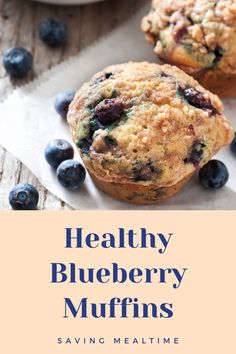 two blueberry muffins on top of a white plate with some blueberries